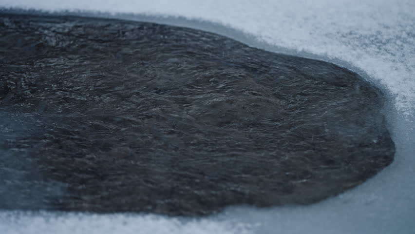 Black River With White Shores. Falling Real Snow. Winter, Cold Weather, Blizzard storm. Romantic wonderland. Landscape, beautiful forest background.