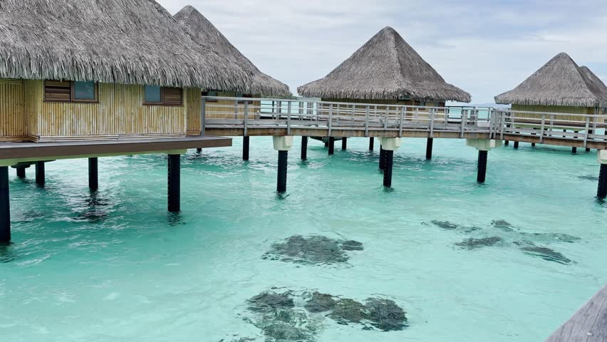 Summer Bora Bora Vacation Resort in French Polynesia with turquoise and aquamarine shallow lagoon clear water