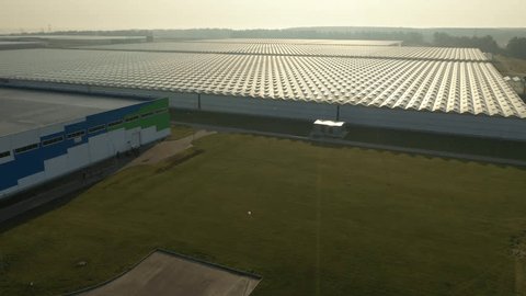Drone Rising over Modern Greenhouse Facilities