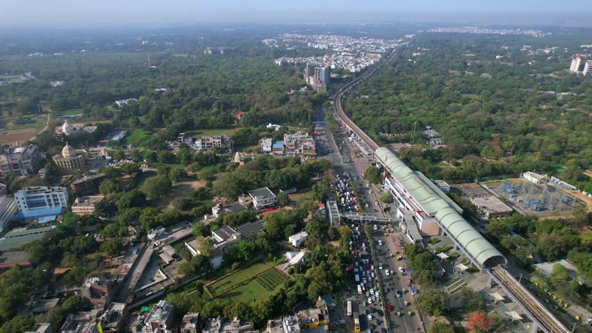 Aerial view of Delhi Metro with road traffic at Chhatarpur Metro Station, New Delhi, India