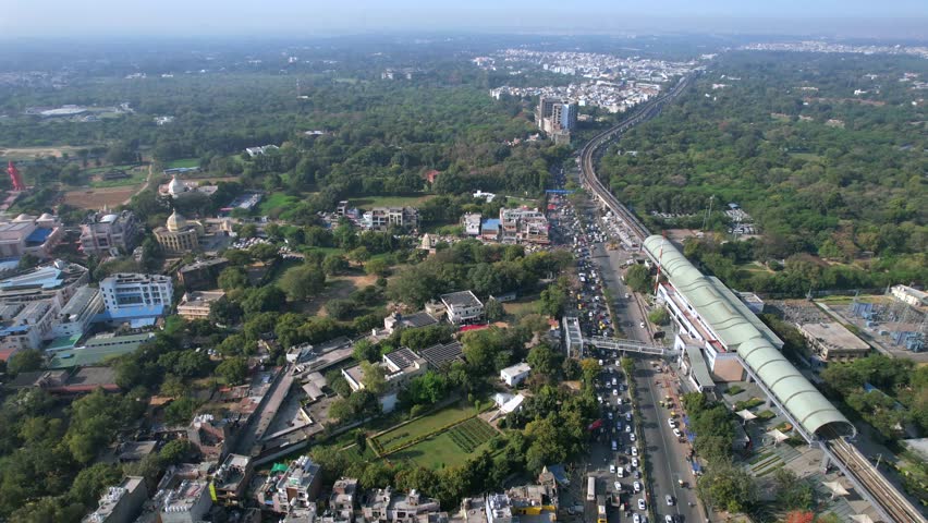 Aerial view of Delhi Metro with road traffic at Chhatarpur Metro Station, New Delhi, India
