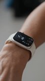 Vertical shot of hands of anonymous sportswoman monitoring fitness progress and pulse on smartwatch during training in gym - Powered by Shutterstock - Get 15% off with code: PIKWIZARD15