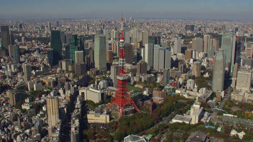 Aerial view of Tokyo Tower in Japan, surrounded by cityscape, capturing iconic architecture, urban life, and vibrant metropolitan scenery.