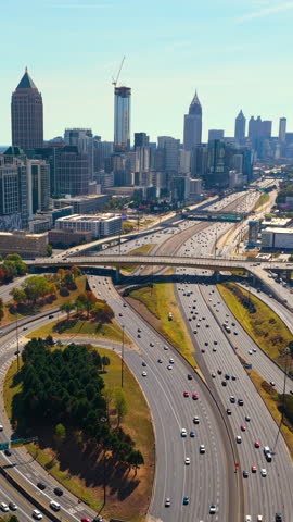 Atlanta, Georgia urban landscape with skyscraper buildings and complex highway interchange connecting interstate speedways. Advanced road design and metropolitan development concept.