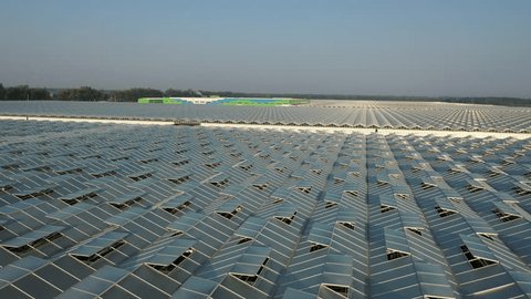 Drone Ascending After Low Flight over Greenhouses