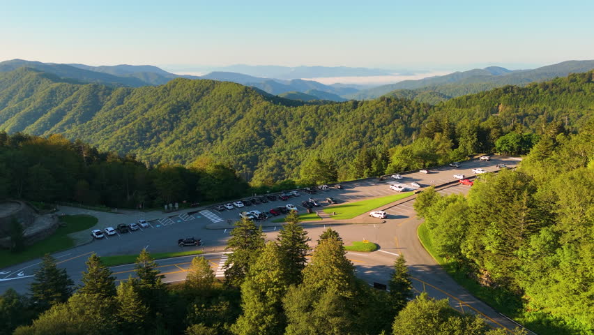 Road trip on scenic drive road in Tennessee Appalachian mountains. Newfound Gap overlook car parking area for hikers and travelers.