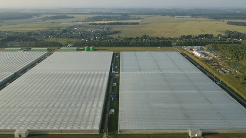 Sideways Aerial Flight above Greenhouse Roofs