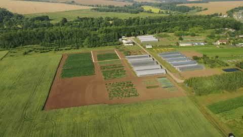 High Altitude Drone Rotating above Greenhouse Complex