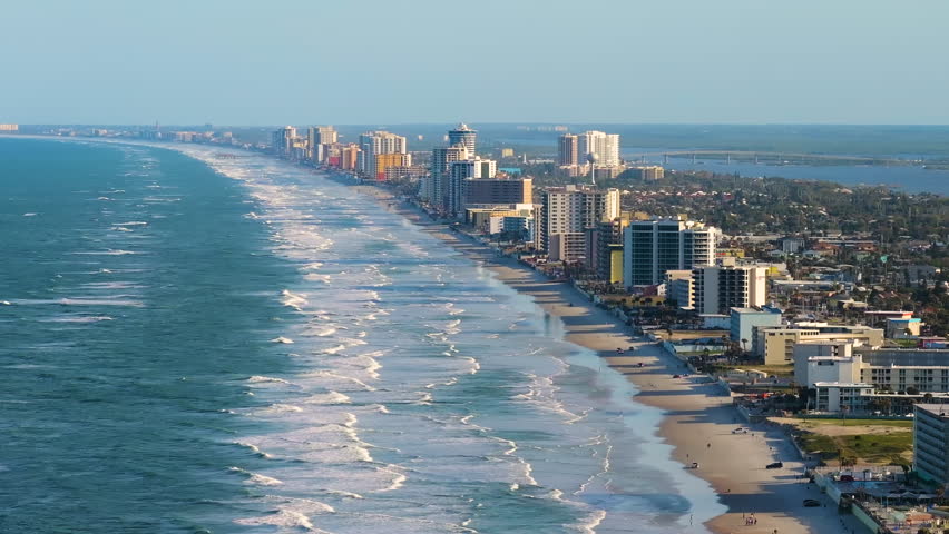 American coastal town of Daytona Beach in Florida. Bright modern apartment buildings and oceanfront hotels with public beach access.