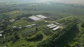 Drone approaching greenhouses and cultivated fields - Powered by Shutterstock - Get 15% off with code: PIKWIZARD15