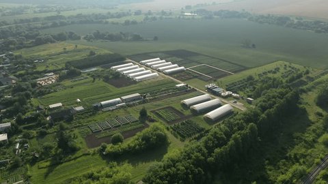 Drone Approaching Greenhouses Cultivated Fields