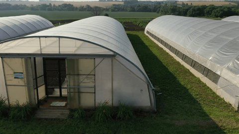 Drone Flying Sideways Past Greenhouses