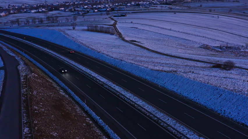 Snowy Rural Landscape At Dusk In Poland, With Tatra Mountains Revealed In Background. aerial tilt-up shot