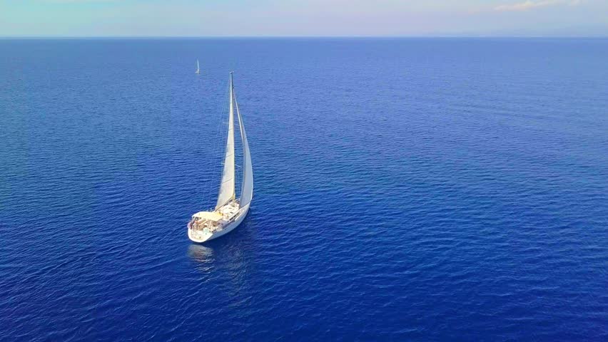 A Serene Sailing Experience on the Open Sea with a Majestic Yacht Gliding Across Tranquil Waters in Greece