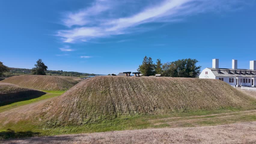 Slow motion footage of Fort Anne National Historic Site in Annapolis Royal Nova Scotia Canada featuring preserved earthwork ramparts historic military buildings and defensive cannons