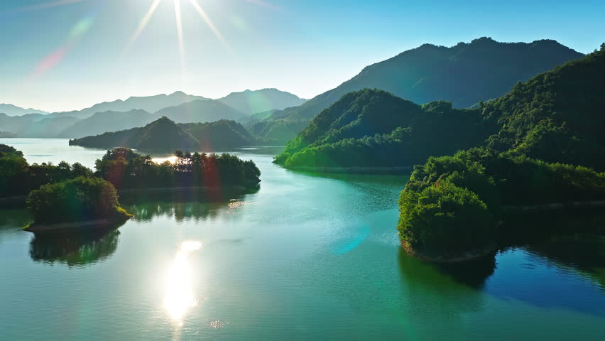 Aerial view of small green islands scattered Qiandao Lake (Thousand Island Lake) with majestic mountains in Hangzhou, China.