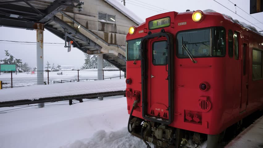 Red Japanese Local Train, Stuck in Snow at Kinosaki Onsen After Blizzard, Japan