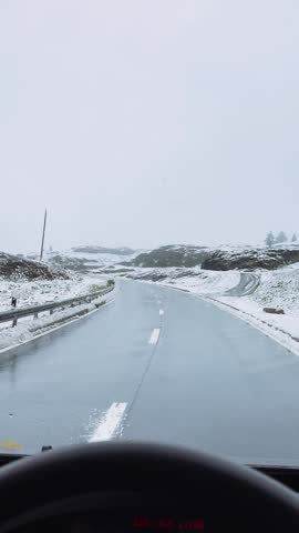 Snowy Road Seen from Car in Switzerland.

View from inside a car driving along a snowy mountain road in Switzerland, winter landscape, cold weather and alpine atmosphere.