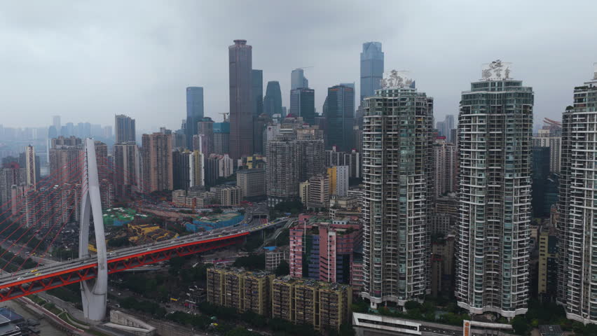 Dongshuimen Bridge Spans The City Surrounded By Tall Buildings And Dense Urban Development In Chongqing, China. - aerial shot