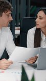 Two business colleagues talking research papers analyzing documents discussion work result in office businesswoman with businessman talk working discuss paperwork using laptop communicate together - Powered by Shutterstock - Get 15% off with code: PIKWIZARD15