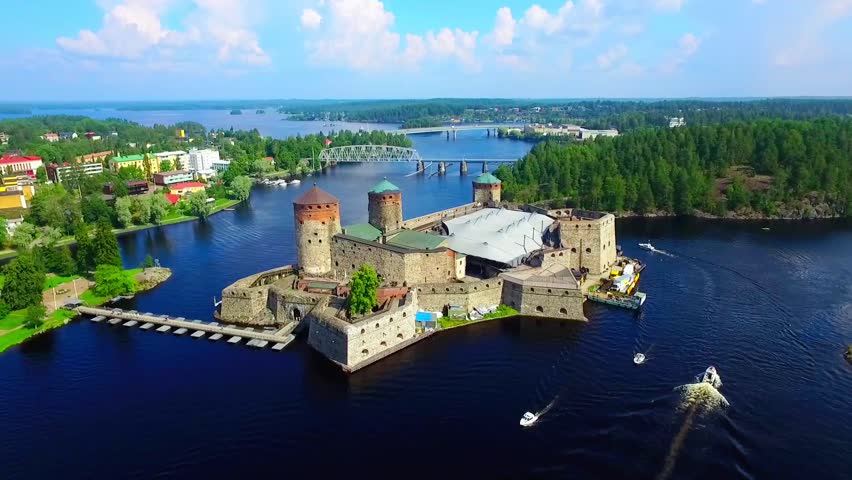 Aerial view of Olavinlinna Medieval Castle in Savonlinna, Finland. Beautiful summer landscape with blue lakes and clear sky
