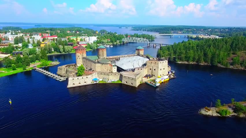 Aerial view of Olavinlinna Medieval Castle in Savonlinna, Finland. Beautiful summer landscape with blue lakes and clear sky
