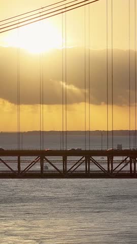 Sunset Sky Over 25 Of April Bridge At Lisbon In Lisbon District Portugal. Sunset Downtown. Freeway Road Landscape. 25 Of April Bridge At Lisbon In Portugal. Cable Stayed Bridge Scenery.