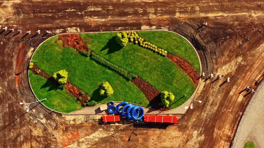 New green space with plants and materials on a bare ground site, showing land transformation