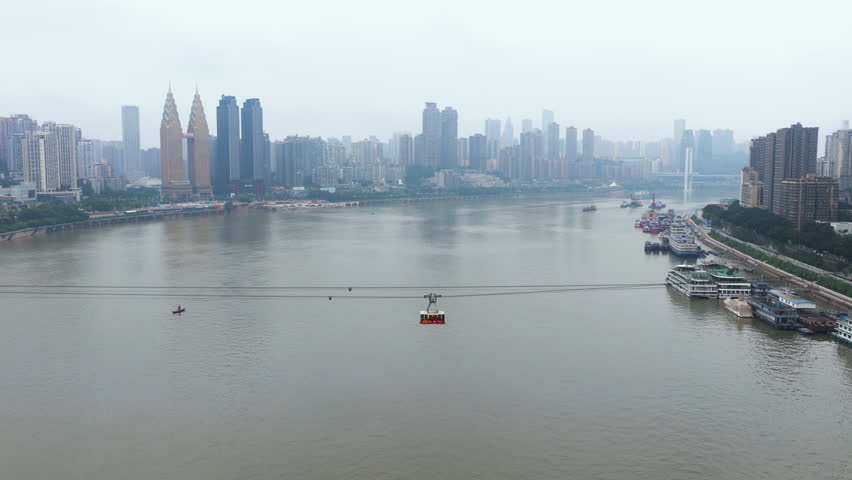 Cableway Crossing Yangtze River With Sheraton Chongqing Hotel In The Background In Chongqing, China. - aerial shot