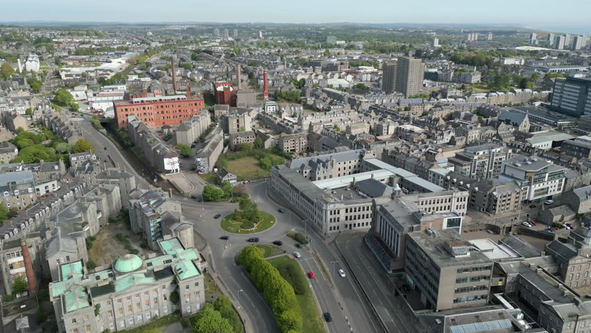 High angle static aerial shot showing the historic Woolmanhill Hospital and surrounding urban architecture in Aberdeen city centre, Scotland.