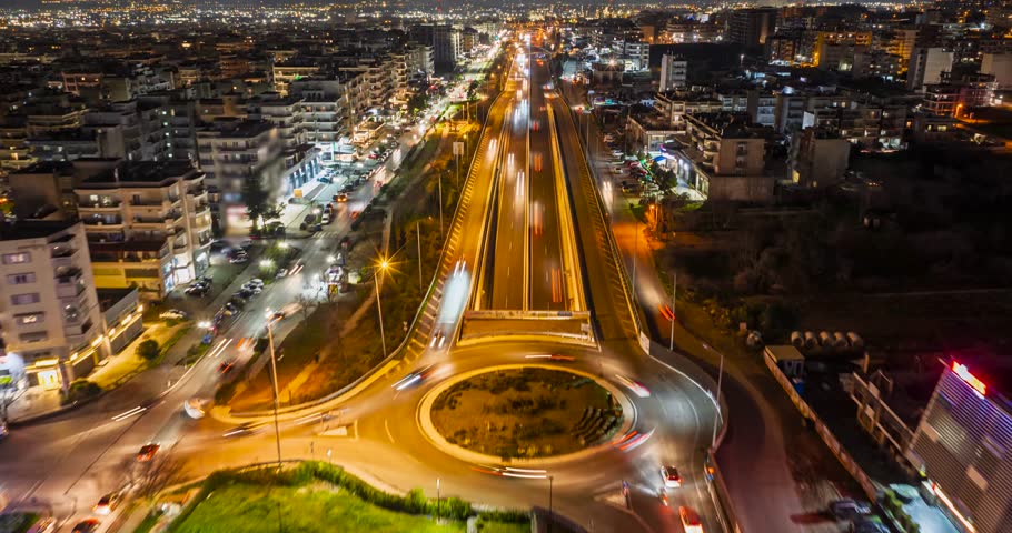 Thessaloniki, Greece — Hyperlapse aerial sequence of the Ring Road in the western districts at night, with dynamic vehicle light trails and illuminated urban infrastructure