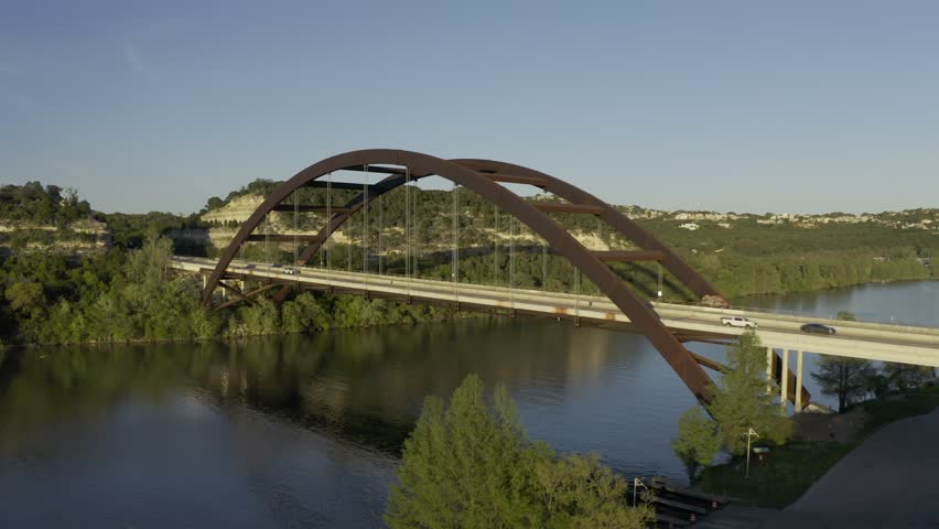Aerial drone footage of the Pennybacker Bridge (360 Bridge) spanning Lake Austin in Austin Texas filmed circa 2020