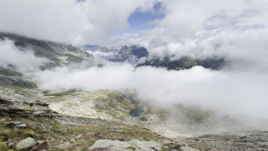 Rising clouds over alpine lakes and peaks - Swiss Alps panorama