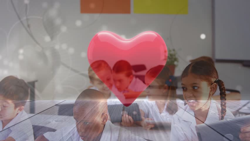 Kids tapping tablets in school, teacher aiding, red heart over group pulsing with sparkle, smiling. Classroom, students, devices, educator, collaboration, education, edtech