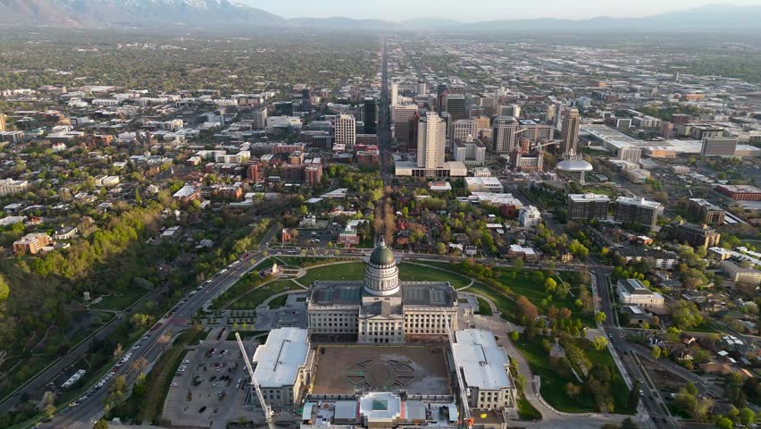 A breathtaking aerial view showcasing Salt Lake City, Utah, with its lush greenery and iconic mountains in the background.