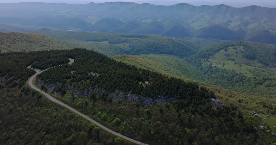 Drone descends above rolling green ridges showcasing expansive terrain around Spruce Knob