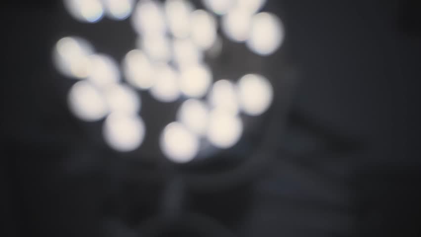 Operation light OT lamps in emergency room overhead lighting equipment in blurry defocused movement. Waking up or falling asleep in hospital surgery. Drugged and dizzy. Tired regain conscious in bed
