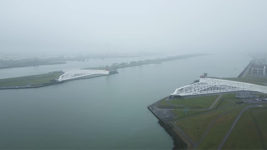 Aerial view of the Maeslantkering protecting Rotterdam harbor and inland Netherlands from North Sea storm surge flooding.