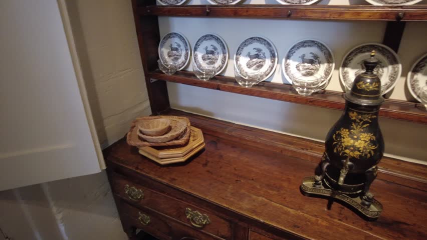 Row of old china plates on cabinet panning shot 4K