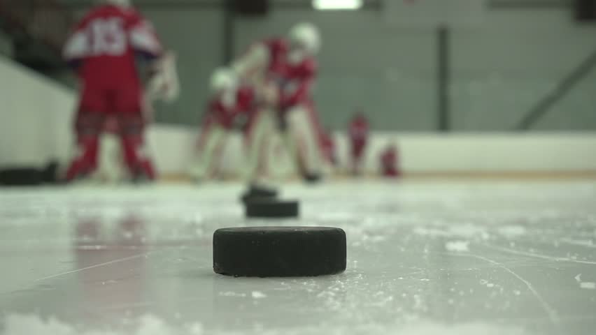 Hockey players training on the ice, practicing drills and teamwork, capturing sports action, athleticism, and preparation for competitive games.