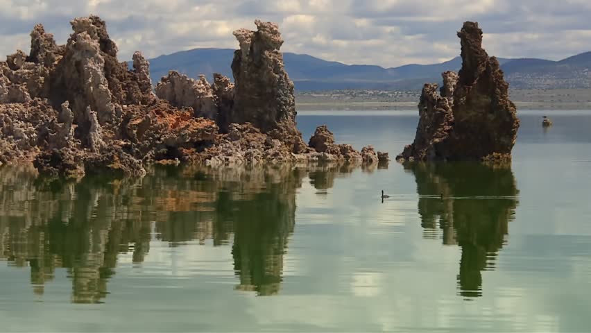 Mono Lake dramatic tufa formations reflected in the calm saline waters in California USA