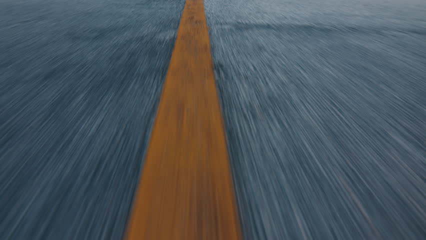 Camera moves fast forward over the asphalt road