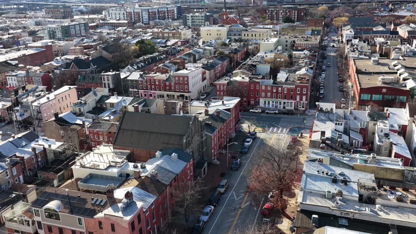Aerial view of Baltimore townhouse neighborhood in winter, with historic brick row houses, urban streets and warm sunlight. Calm American residential atmosphere in USA. Old homes in classical design.
