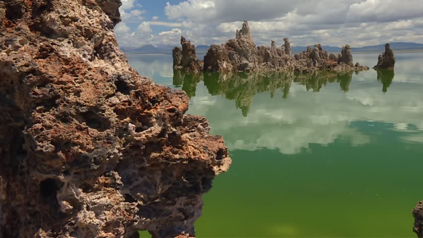 Mono Lake tufa towers forming unique geological structures, reflecting the sky and surrounding environment
