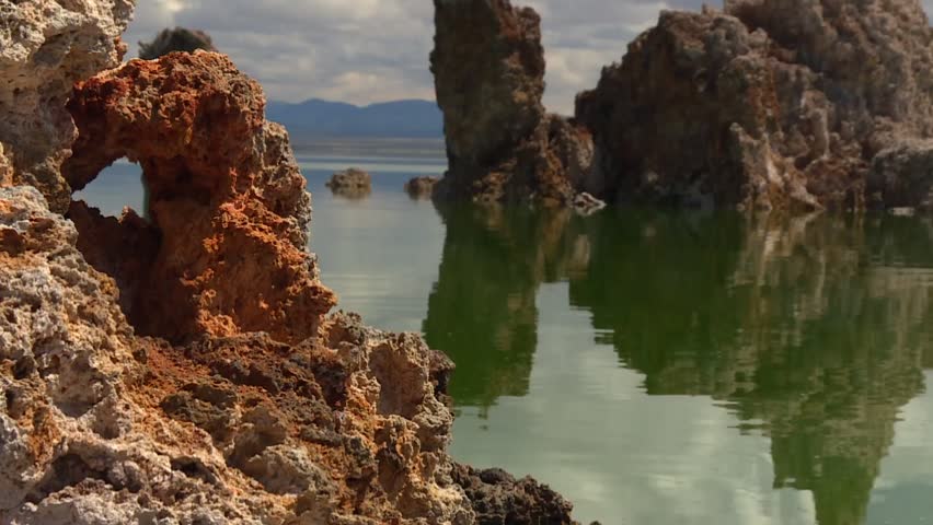 Tufa spires stand in Mono Lake with distinctive shapes and clear reflections on the water surface