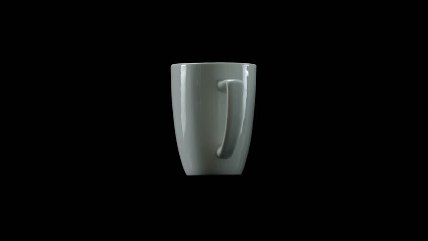 Minimal studio shot of a white ceramic mug slowly rotating on black background for clean product display.