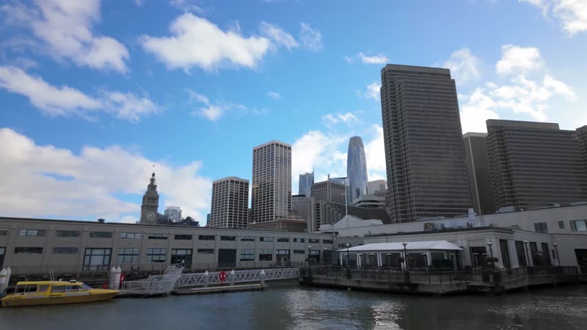 Gimbal wide panning shot of the downtown San Francisco skyline from Pier 3 Hornblower Landing in Northern California. 4K
