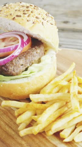 Vertical video: Frame three burger and fries drawing icons, popping, grouping, fading, showing buzz. Hamburger, sesame, lettuce, onion, potatoes, rustic, vertical video
