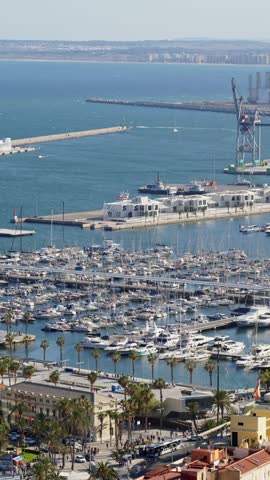 Panoramic view of a busy harbor filled with numerous yachts and boats docked in a sunny bay