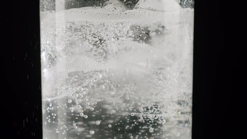 Refreshing sparkling mineral water or tonic perfect for a cool beverage on a hot summer day. Carbonated sparkling mineral water with ice cubes. Fizzy sparkling water with ice cubes and bubbles.